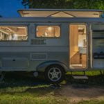 a small rv with a door open