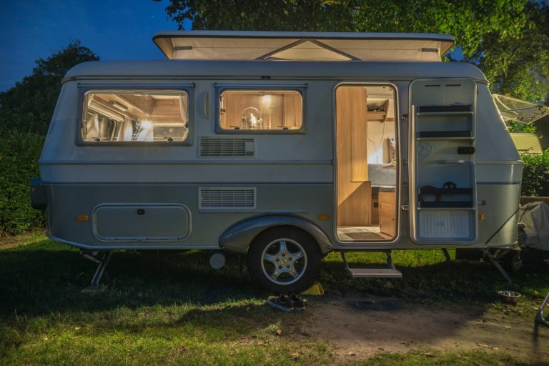 a small rv with a door open