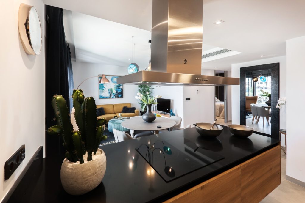 a kitchen with black counter tops