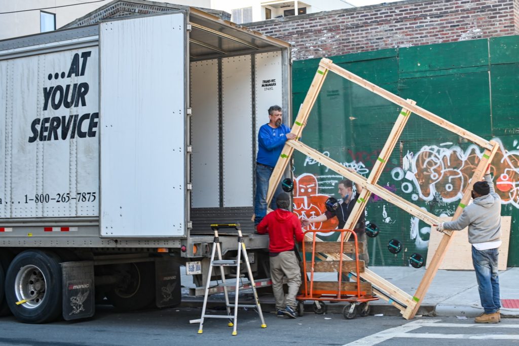 a group of people loading a truck