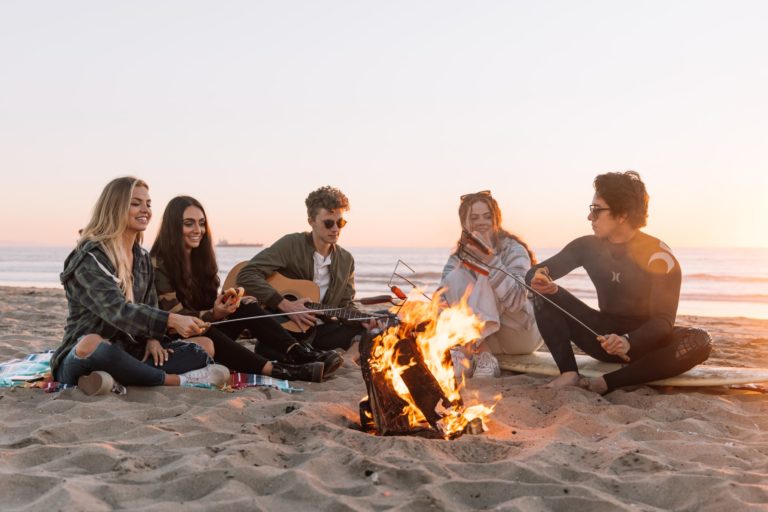 a group of people sitting on the beach